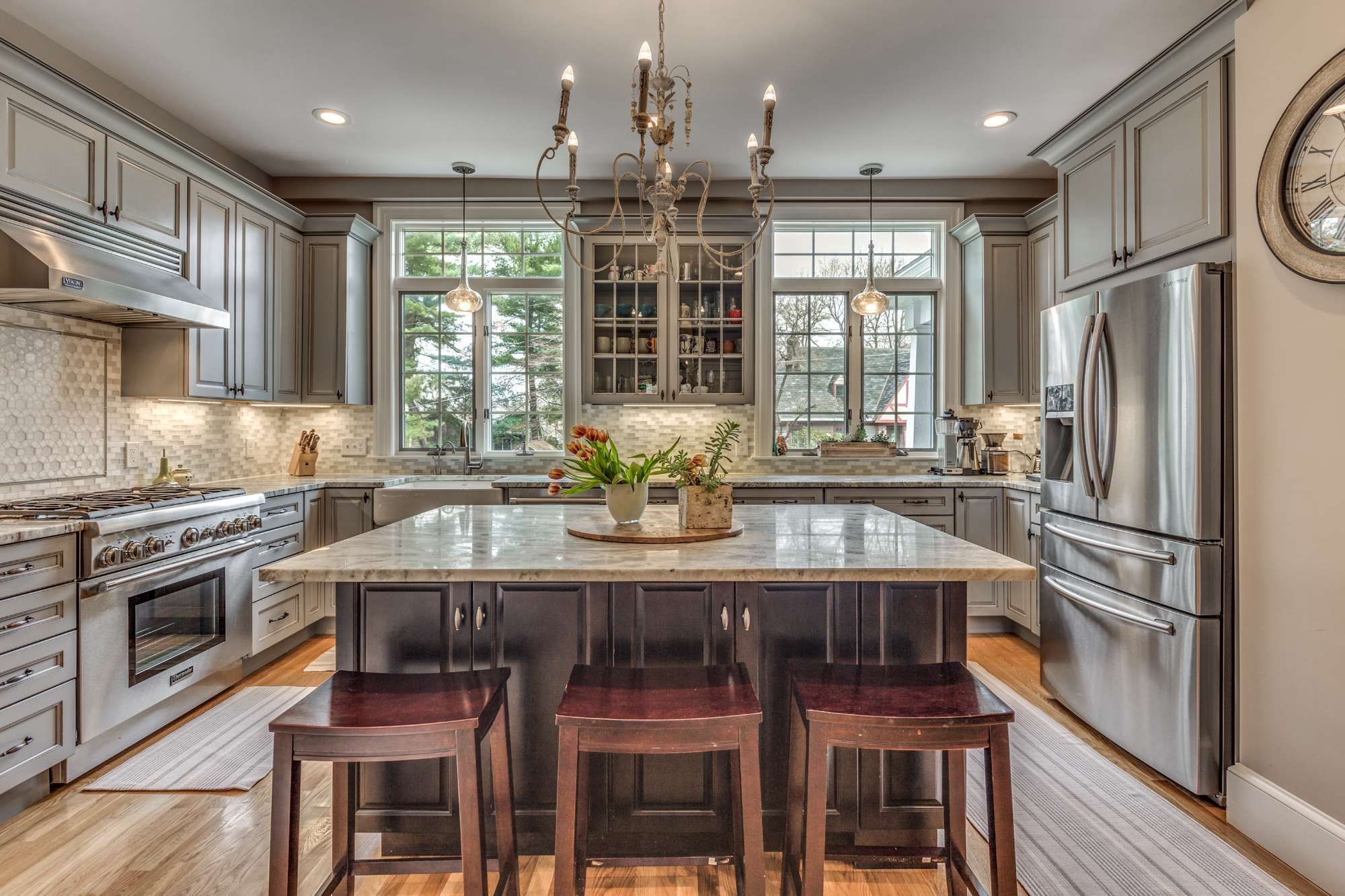 Symmetrical kitchen design in Winchester, MA by Pegasus Design-to-Build showcasing a central island and custom cabinetry-optimized