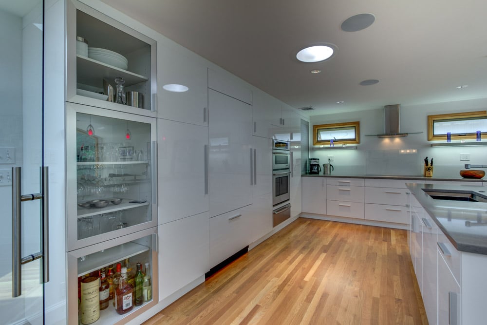 bright kitchen renovation with island sink and large windows by PEGASUS Design-to-Build in Arlington, MA