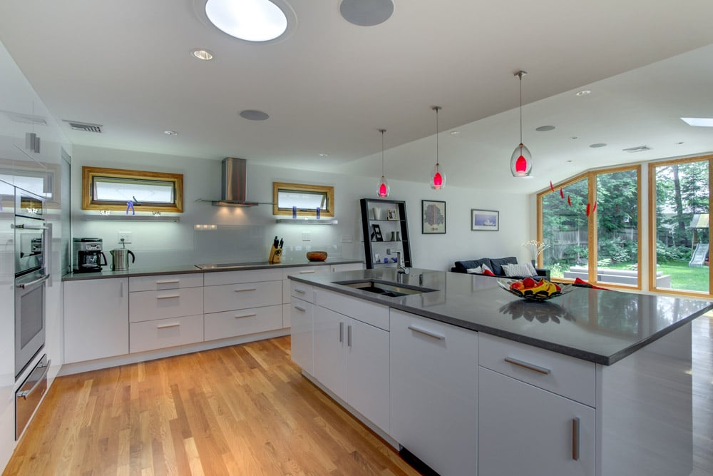 bright open kitchen with island sink and backyard views by PEGASUS Design-to-Build in Arlington, MA