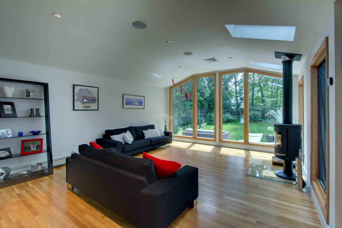 living space with wood stove and large windows in kitchen renovation by PEGASUS Design-to-Build in Arlington, MA-optimized