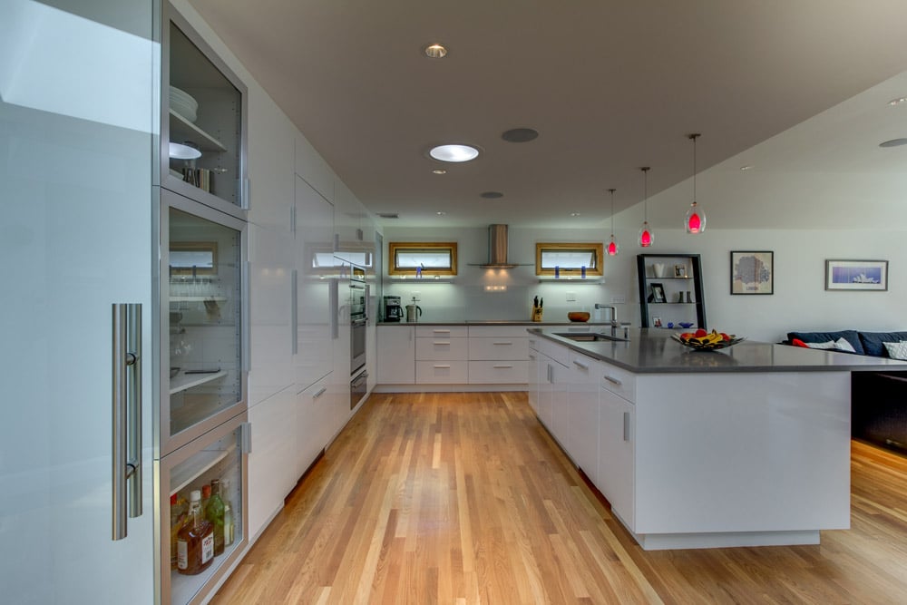 modern kitchen and dining area with outdoor access and natural light by PEGASUS Design-to-Build in Arlington, MA