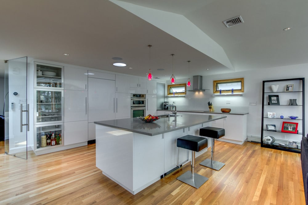 modern kitchen renovation with large island and bar seating by PEGASUS Design-to-Build in Arlington, MA