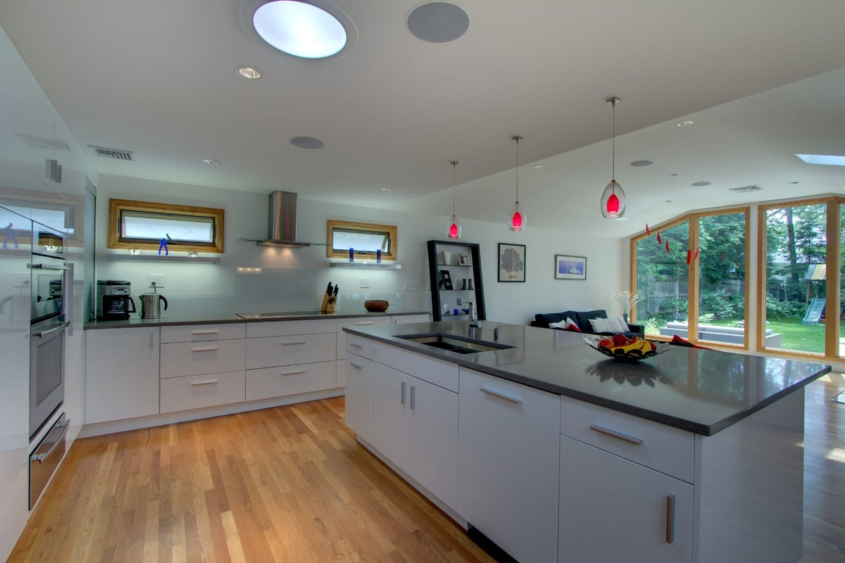 open kitchen with modern island and backyard views by PEGASUS Design-to-Build in Arlington, MA-optimized