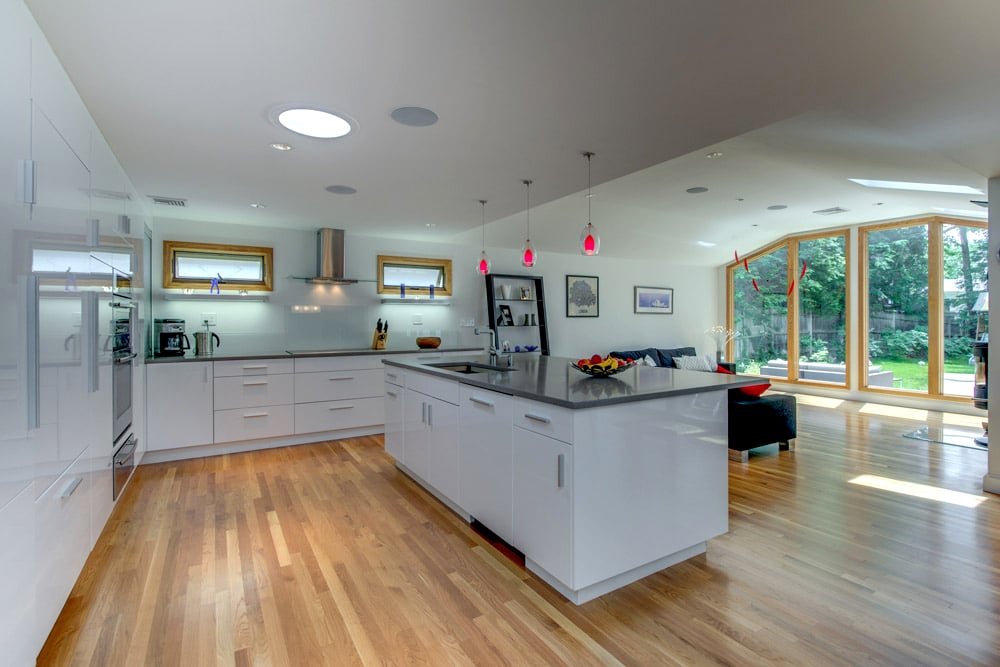 open-concept kitchen and dining remodel with glass doors by PEGASUS Design-to-Build in Arlington, MA