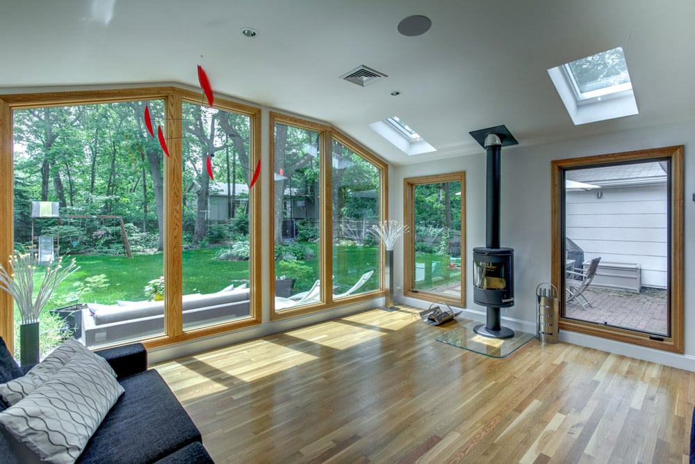 sunlit living area with large windows and wood stove in kitchen renovation by PEGASUS Design-to-Build in Arlington, MA