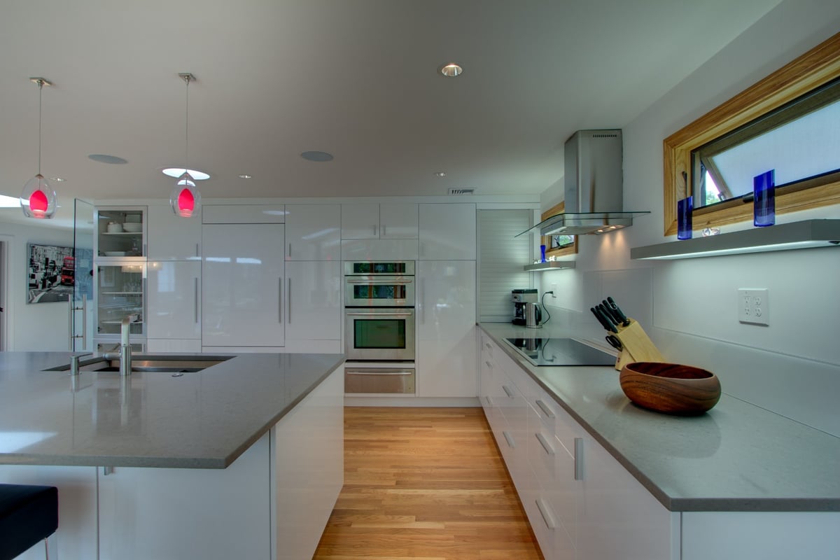 updated kitchen design with minimalist cabinets and wood flooring by PEGASUS Design-to-Build in Arlington, MA-optimized