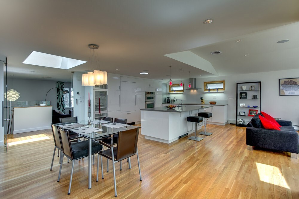 wide view of modern kitchen and dining remodel with skylight by PEGASUS Design-to-Build in Arlington, MA