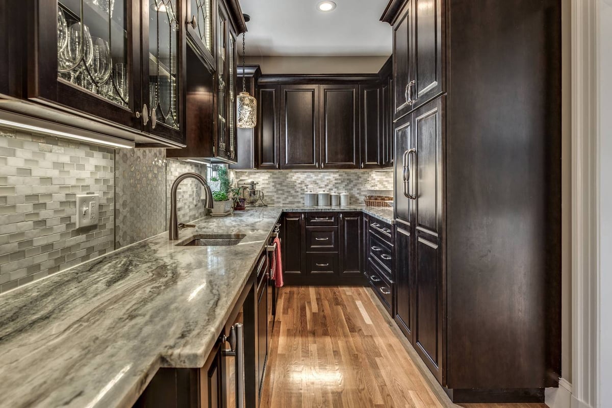 Narrow pantry renovation in Winchester, MA by Pegasus Design-to-Build featuring built-in cabinets and hardwood floors-optimized