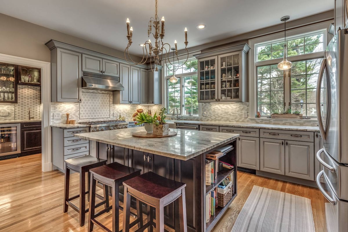 Spacious remodeled kitchen in Winchester, MA by Pegasus Design-to-Build featuring a large island, pendant lighting, and stainless appliances-optimized