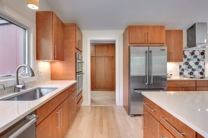 bright kitchen addition with wood cabinets and large island by PEGASUS Design-to-Build in Lexington, MA