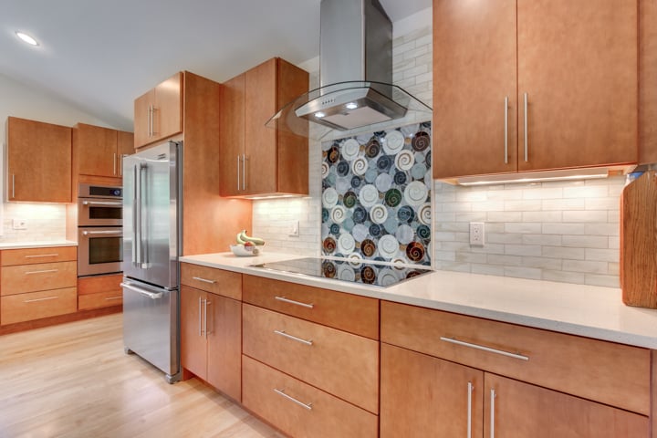 close-up of kitchen remodel with decorative tile backsplash and hood by PEGASUS Design-to-Build in Lexington, MA