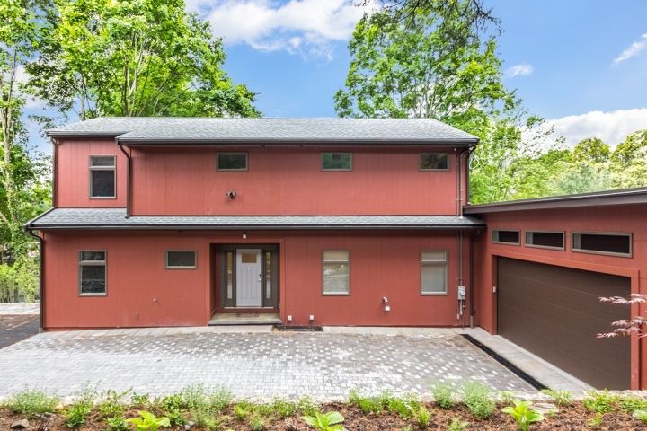 modern home exterior addition with red siding and attached garage by PEGASUS Design-to-Build in Lexington, MA-optimized