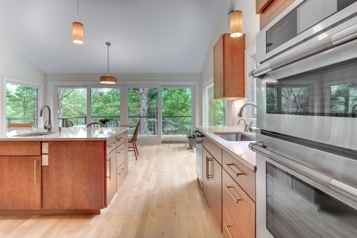 modern kitchen with island seating and natural light from outdoor views by PEGASUS Design-to-Build in Lexington, MA-optimized