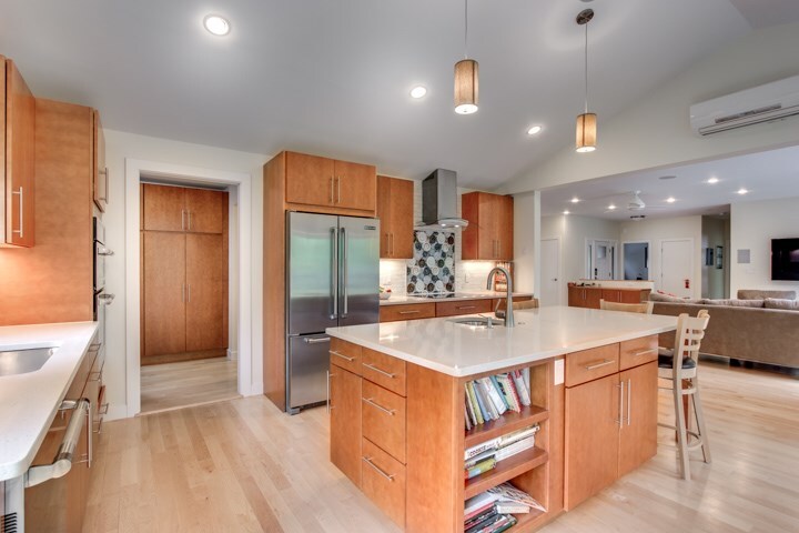 open kitchen addition with island and stainless steel appliances by PEGASUS Design-to-Build in Lexington, MA