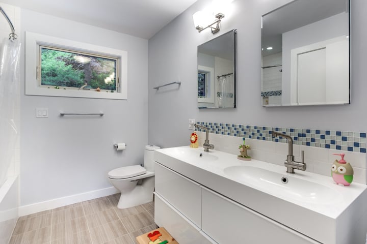 updated bathroom with double vanity and natural light by PEGASUS Design-to-Build in Lexington, MA