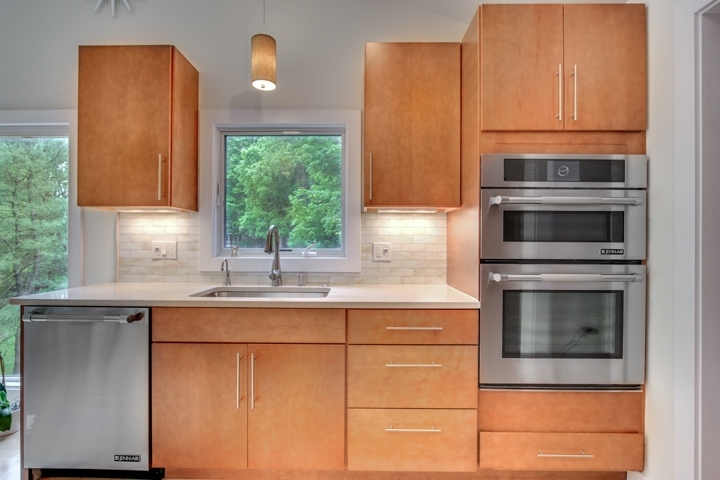 updated kitchen with stainless appliances and wood cabinets by PEGASUS Design-to-Build in Lexington, MA-optimized