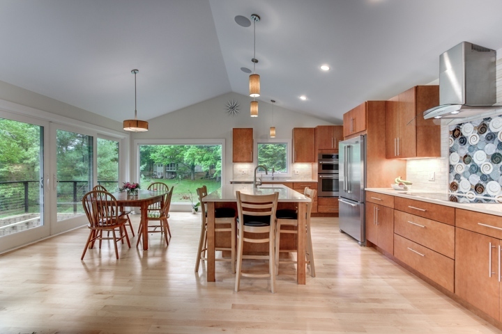 wide view of kitchen addition with island and dining area by PEGASUS Design-to-Build in Lexington, MA-optimized