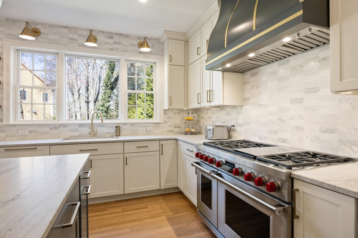 modern kitchen sink area with expansive windows and cabinetry by PEGASUS Design-to-Build in Lexington, MA
