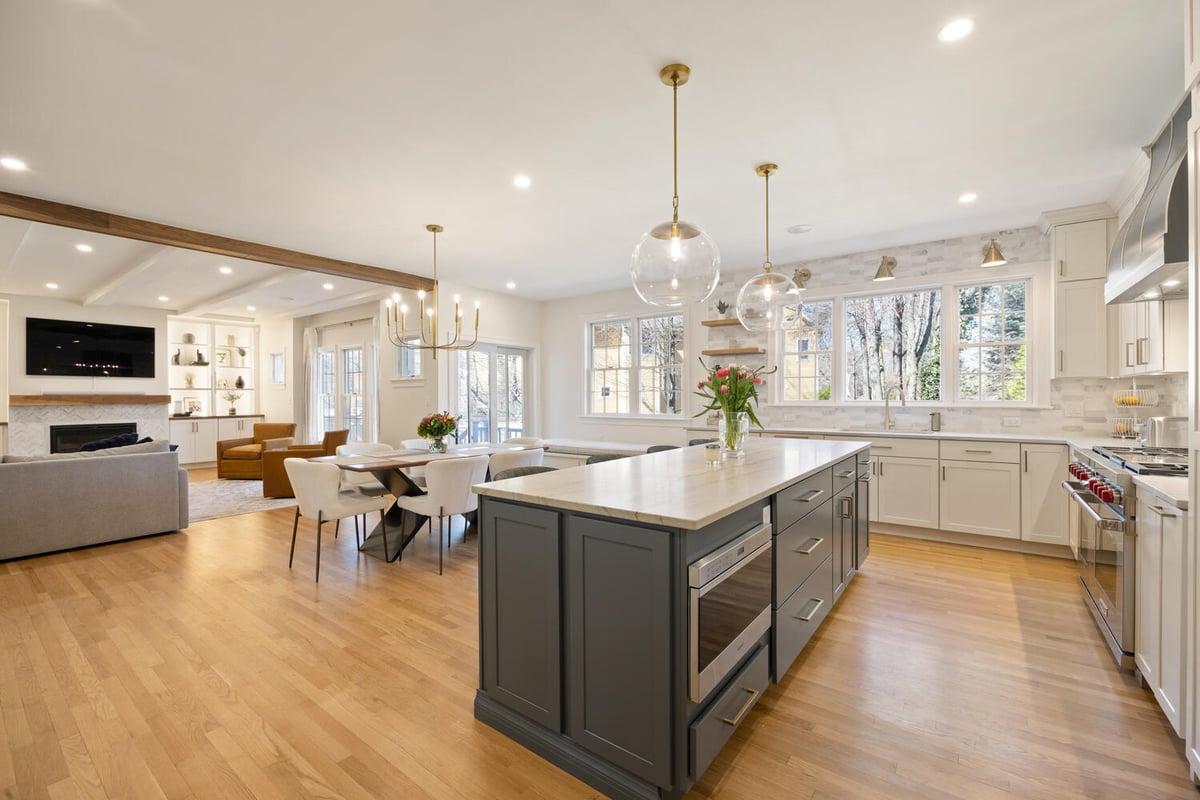 modern open concept kitchen with island and living room view by PEGASUS Design-to-Build in Lexington, MA