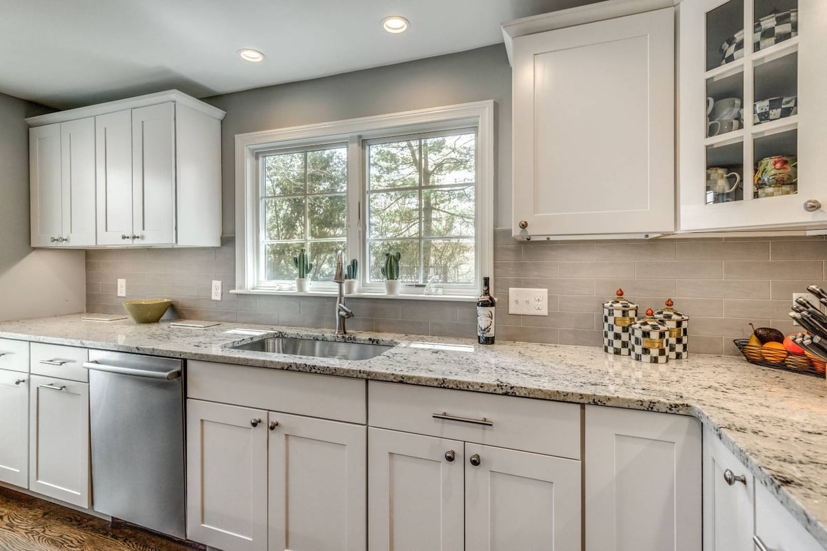 Bright kitchen workspace in Lexington, MA renovation by PEGASUS Design-to-Build featuring granite counters and window lighting-optimized
