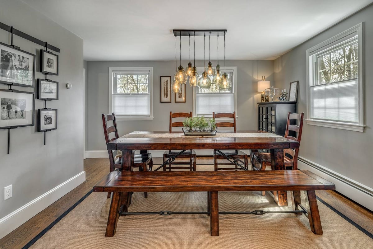 Dining room remodel in Lexington, MA by PEGASUS Design-to-Build with rustic wood table and modern pendant lighting-optimized