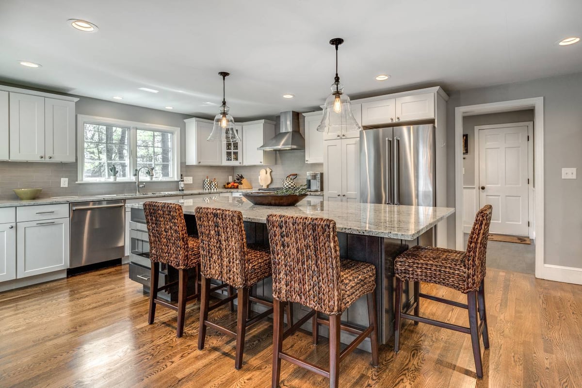 Modern kitchen remodel in Lexington, MA by PEGASUS Design-to-Build with large island and woven bar stools-optimized