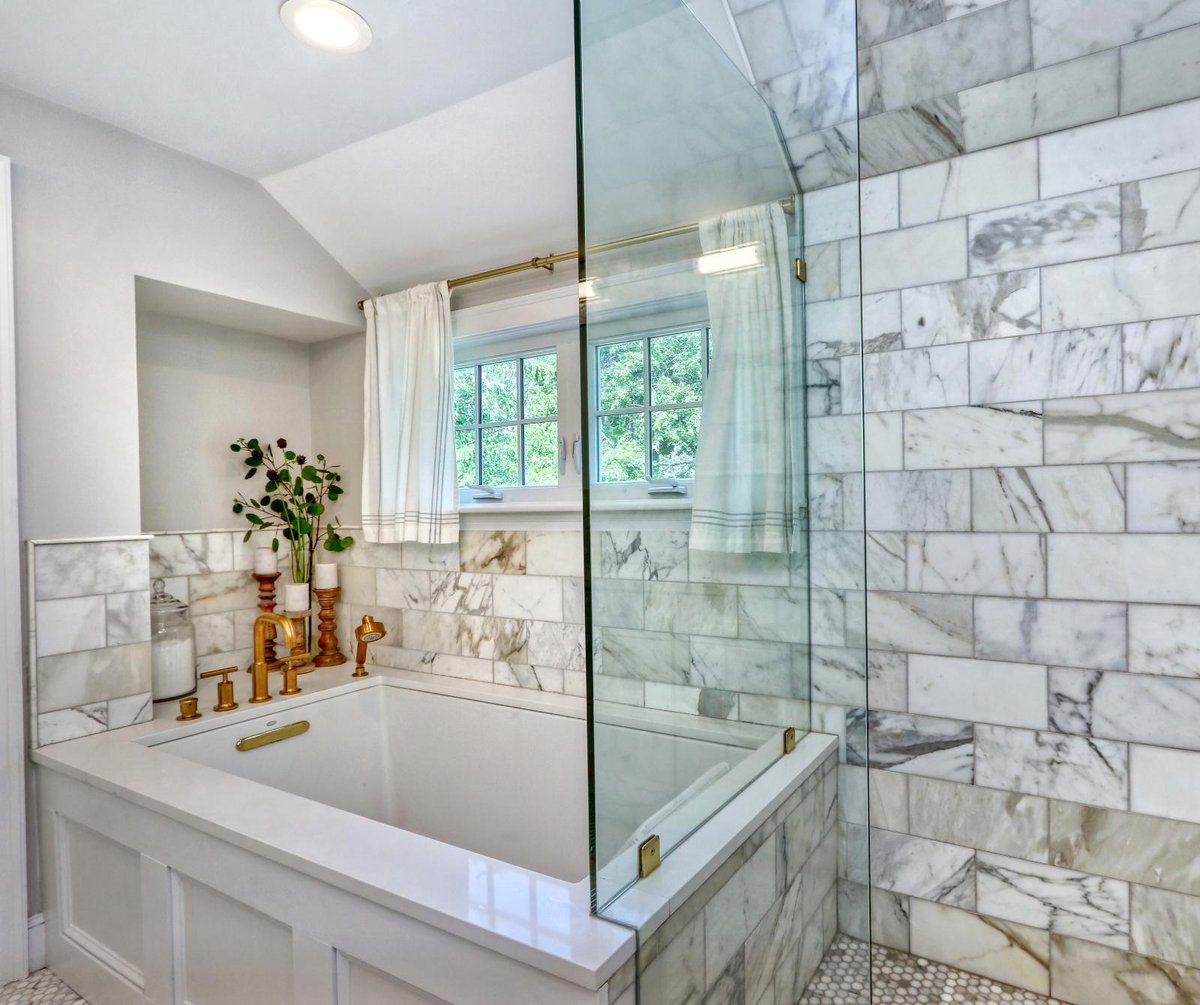 Luxury bathroom remodel in Melrose, MA by PEGASUS Design-to-Build with soaking tub and marble tile surround.-optimized