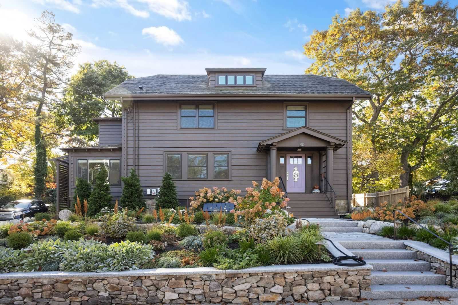 Front exterior of renovated home with landscaped yard by PEGASUS Design-to-Build in Melrose, MA kitchen and addition renovation-optimized