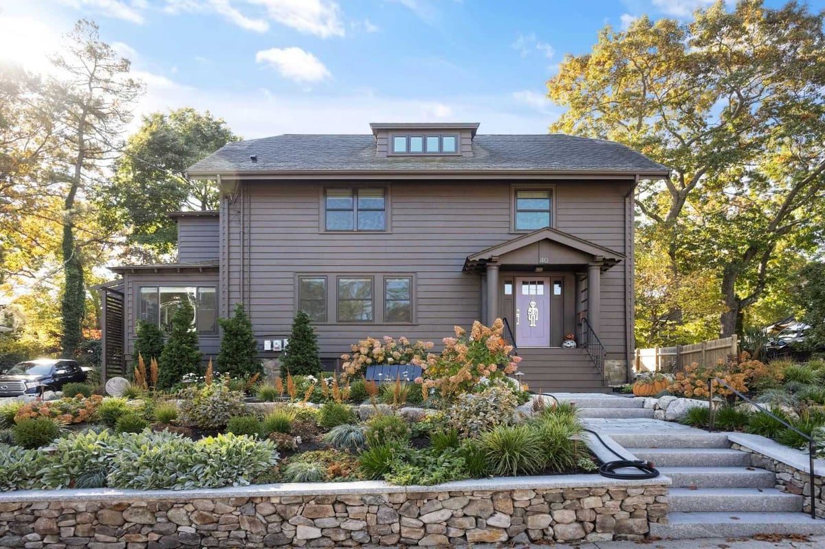 Front exterior of renovated home with landscaped yard by PEGASUS Design-to-Build in Melrose, MA kitchen and addition renovation-optimized