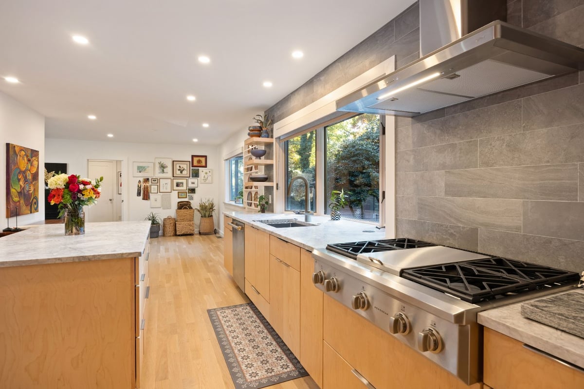 Modern kitchen with gas range and tile backsplash by PEGASUS Design-to-Build in Melrose, MA kitchen and addition renovation-optimized