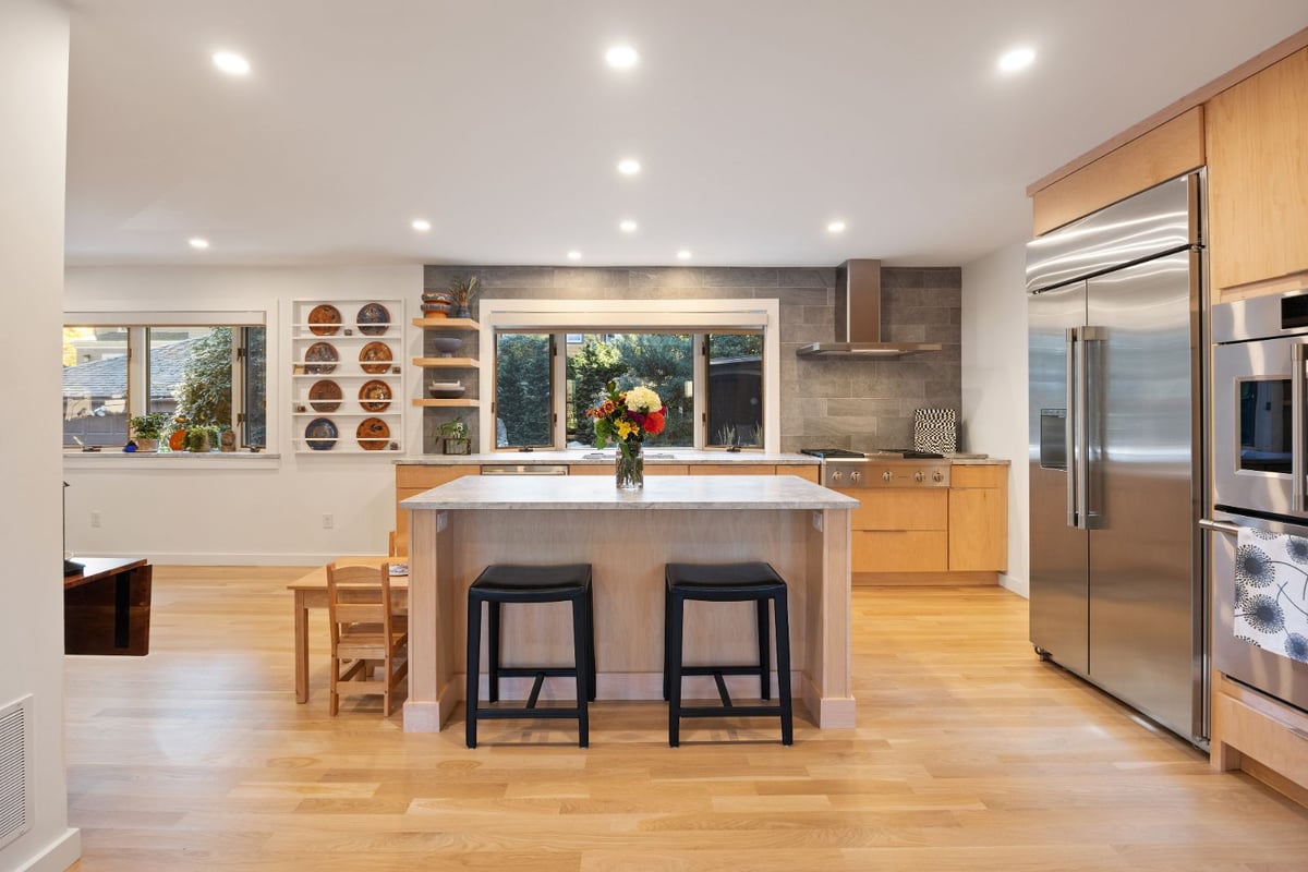 Updated kitchen design with wood cabinetry and large island by PEGASUS Design-to-Build in Melrose, MA kitchen and addition renovation-optimized