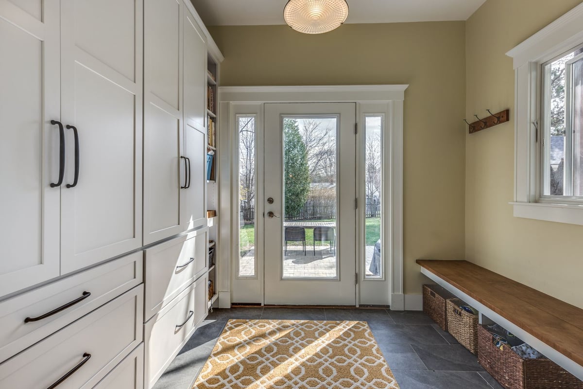 Bright mudroom with backyard access in Melrose MA renovation by PEGASUS Design-to-Build with built-in cabinets-optimized