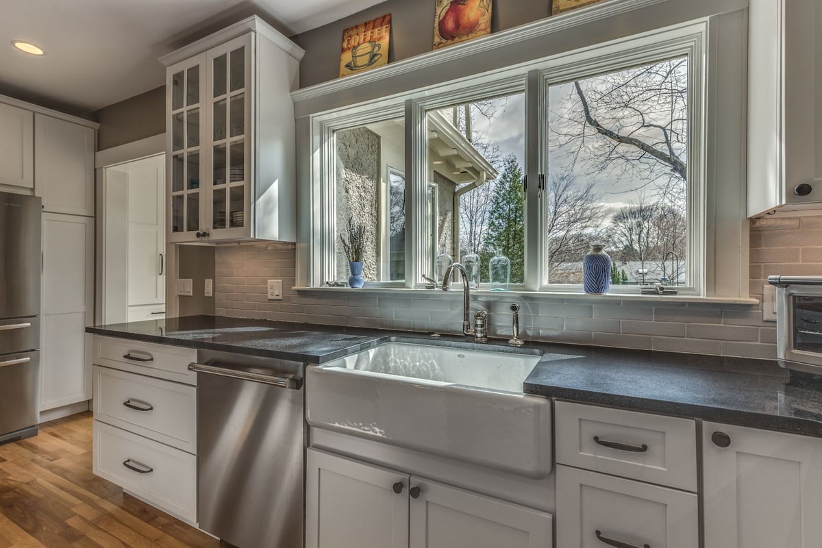 Farmhouse sink and window detail in Melrose MA kitchen remodel by PEGASUS Design-to-Build with white cabinetry-optimized