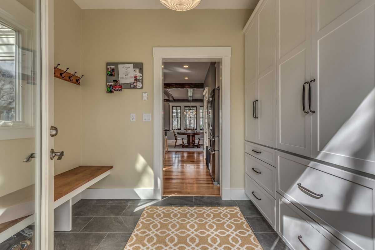 Mudroom to kitchen view in Melrose MA remodel by PEGASUS Design-to-Build with hardwood floors and built-ins-optimized