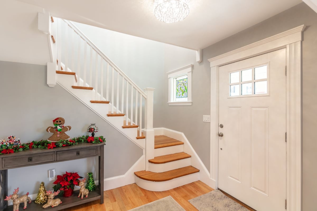 bright entryway with staircase and hardwood floors in Melrose MA home renovation by PEGASUS Design-to-Build-optimized