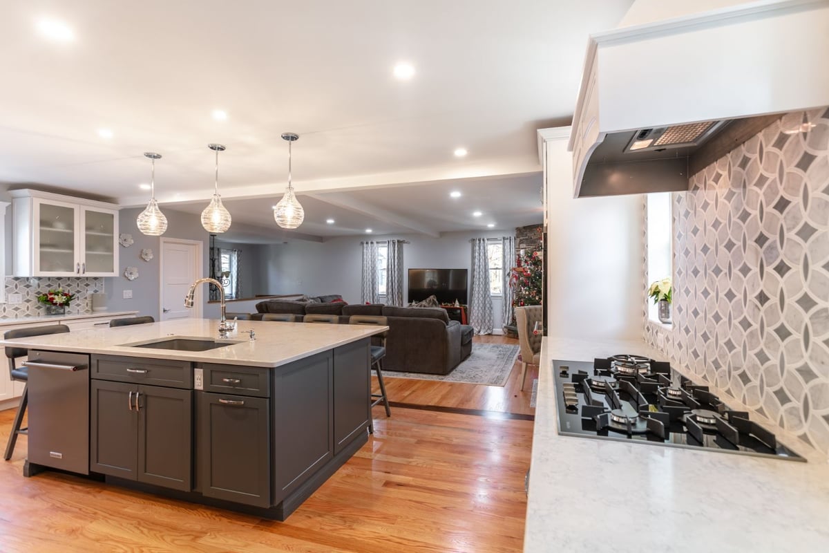 kitchen island and living room view with hardwood floors in Melrose MA by PEGASUS Design-to-Build-optimized