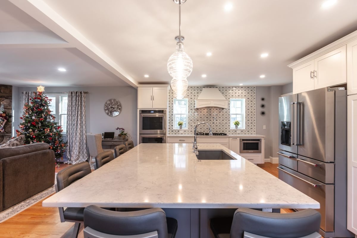 large kitchen island with seating and pendant lights in Melrose MA by PEGASUS Design-to-Build-optimized