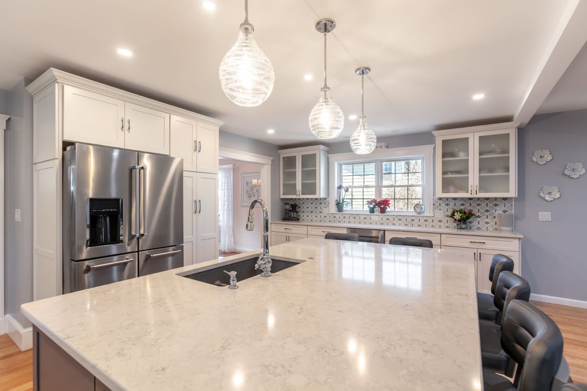large kitchen island with sink and pendant lighting in Melrose MA by PEGASUS Design-to-Build-optimized