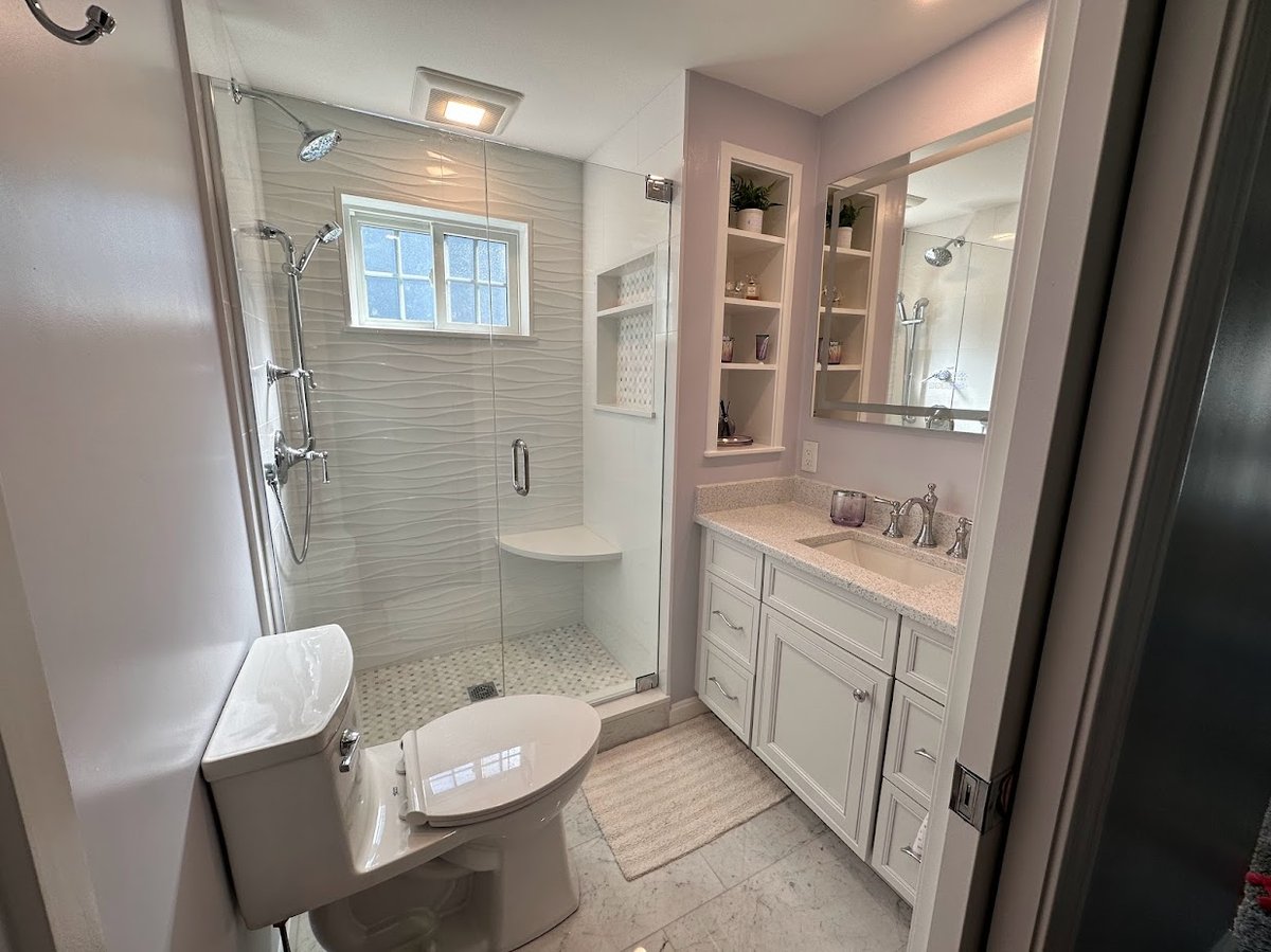 narrow bathroom with glass shower and vanity in Melrose MA by PEGASUS Design-to-Build