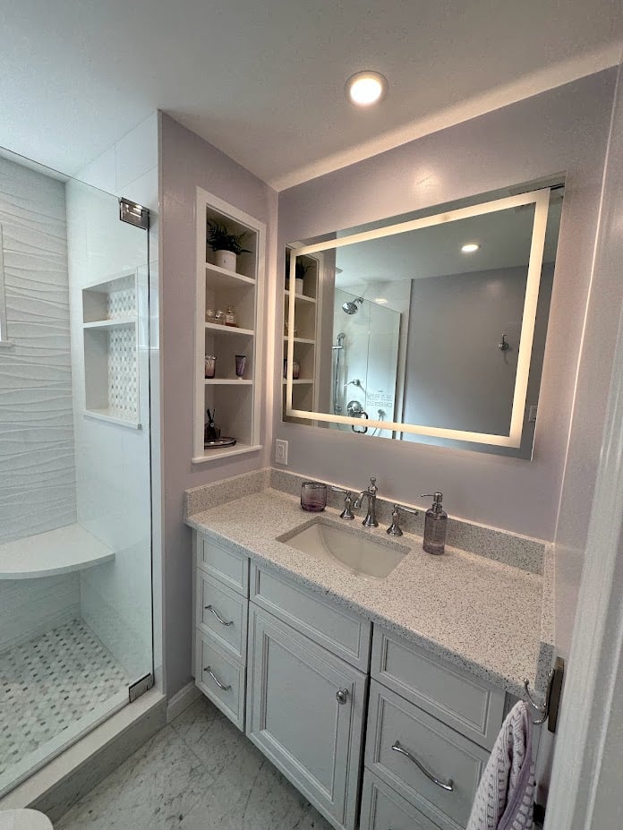 small bathroom vanity with glass shower and built-in shelving in Melrose MA by PEGASUS Design-to-Build