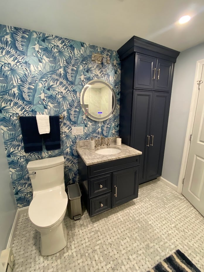 stylish powder room with patterned wallpaper and vanity in Melrose MA by PEGASUS Design-to-Build
