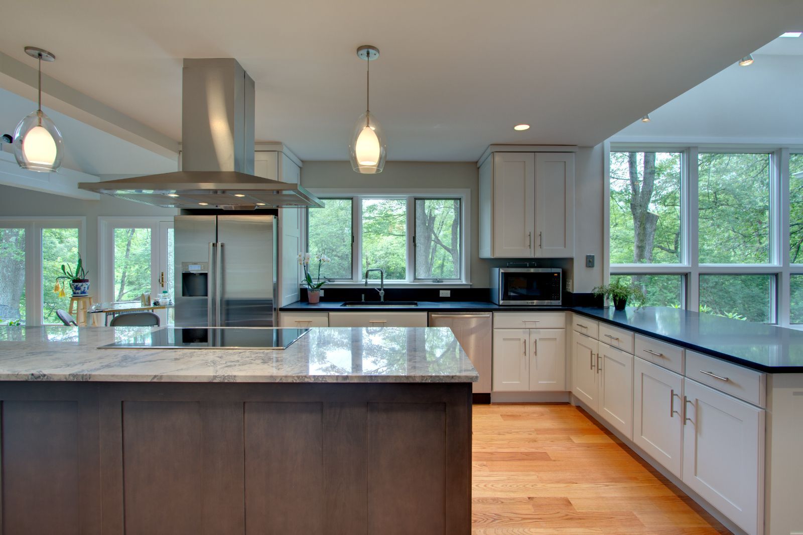Elegant kitchen renovation in Wellesley, MA by PEGASUS Design-to-Build with marble island and large windows-optimized