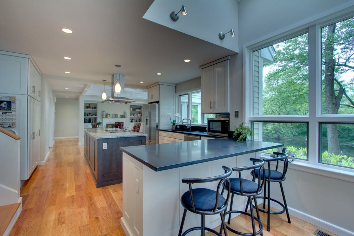 Open kitchen renovation with peninsula seating and natural light in North Shore MA by PEGASUS Design-to-Build-optimized