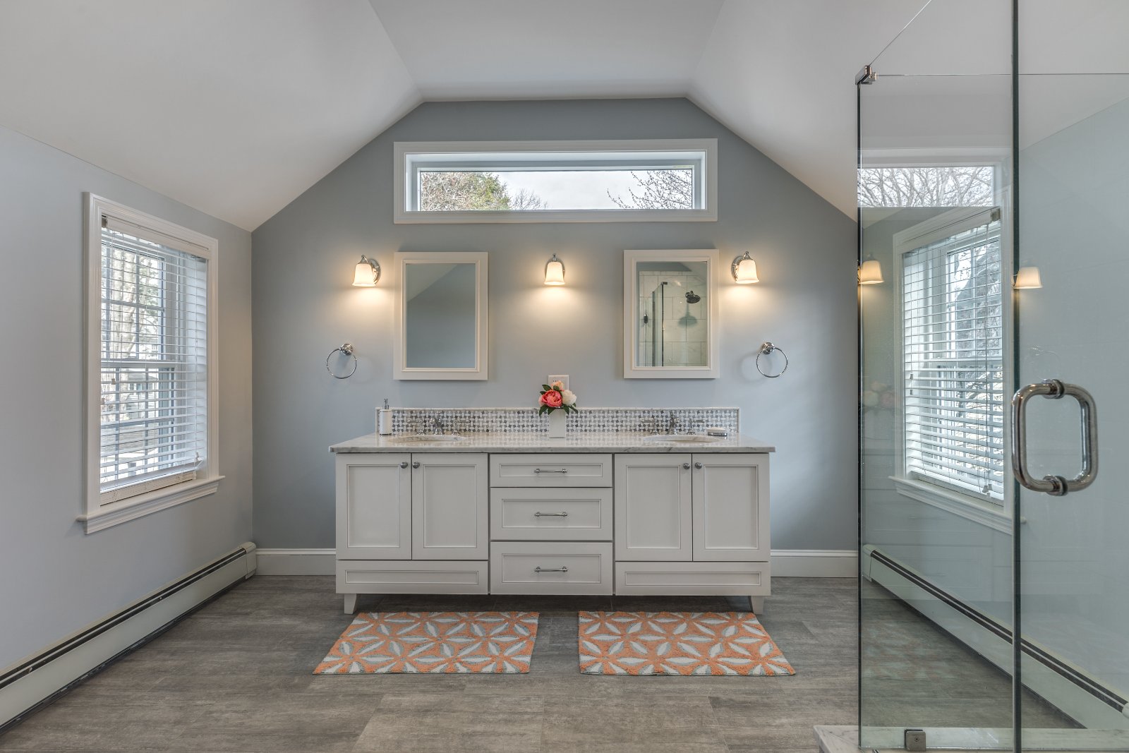 Bathroom remodel in Melrose, MA by Pegasus Design-to-Build with double vanity and modern lighting-optimized