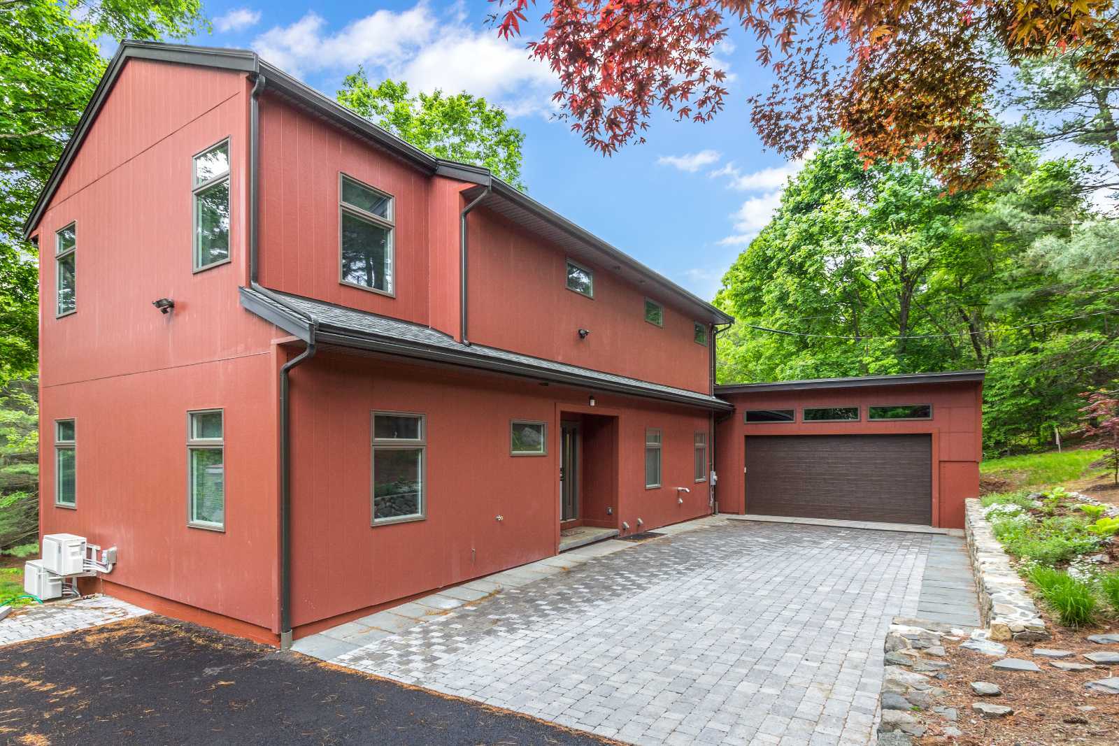 Custom home exterior in Arlington, MA by Pegasus Design-to-Build featuring modern siding and attached garage-optimized