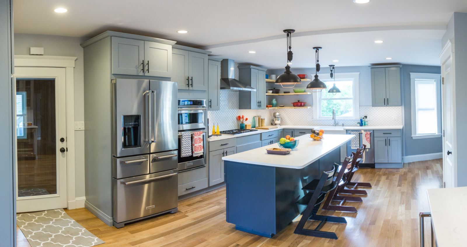 Kitchen remodel in Arlington, MA by Pegasus Design-to-Build with gray cabinetry and large island seating-optimized
