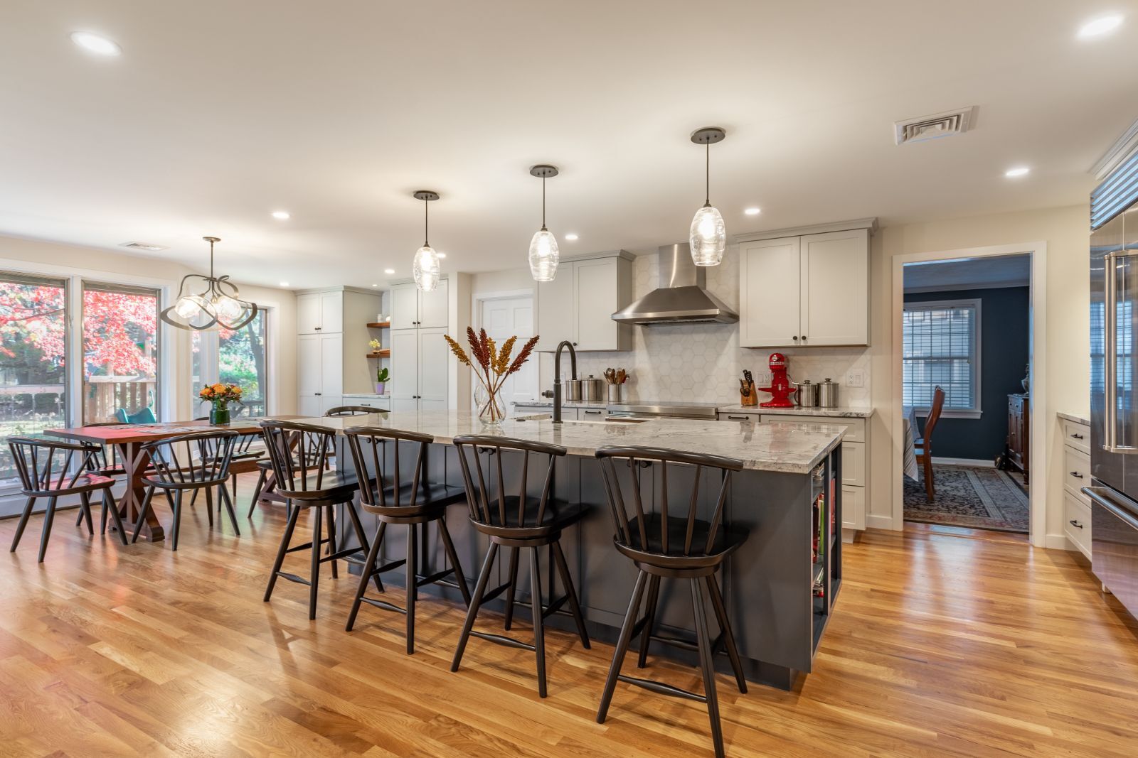 Open kitchen remodel in Winchester, MA by Pegasus Design-to-Build with large island and dining area-optimized