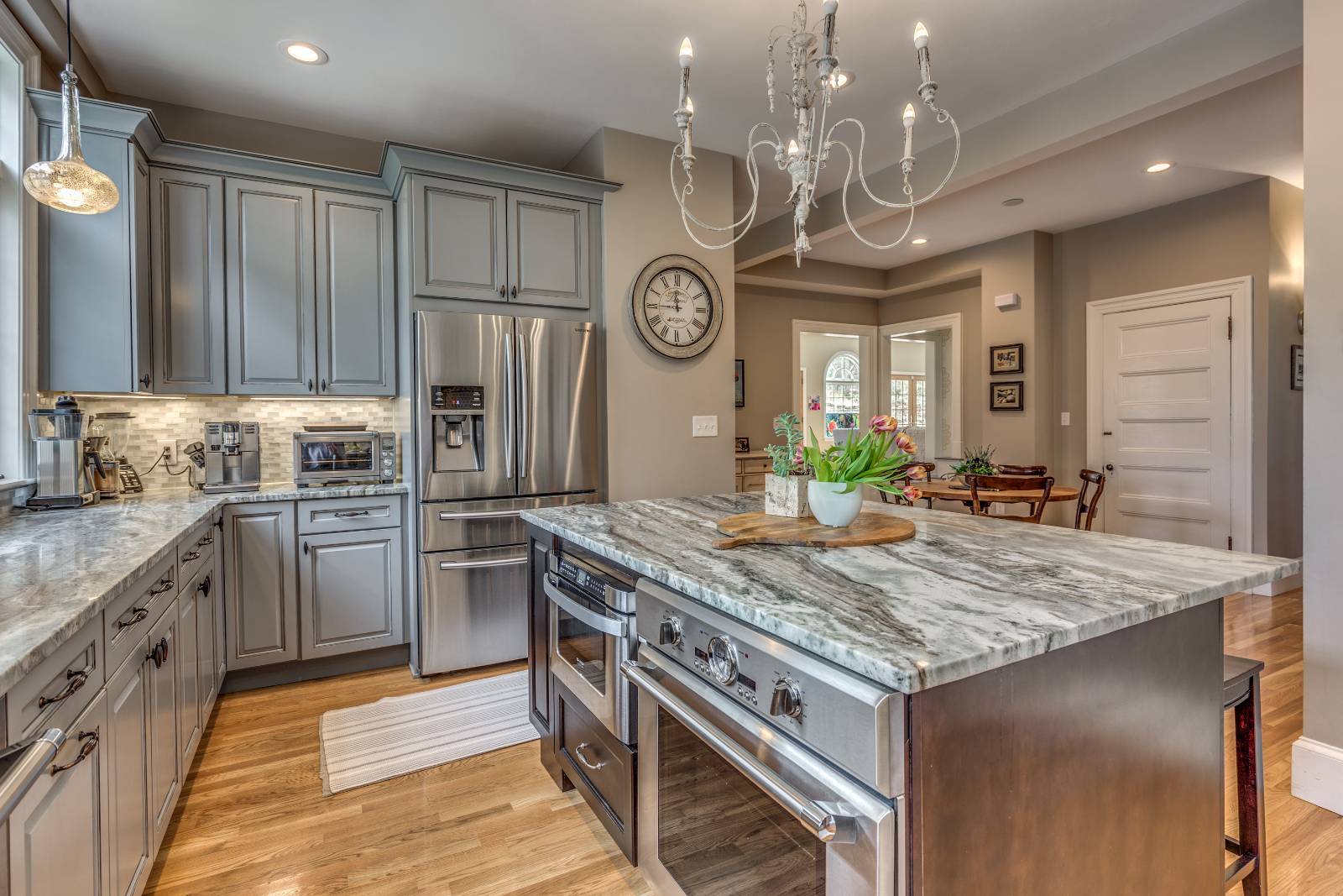 Modern kitchen renovation in Winchester, MA by Pegasus Design-to-Build with stainless steel appliances and marble island-optimized