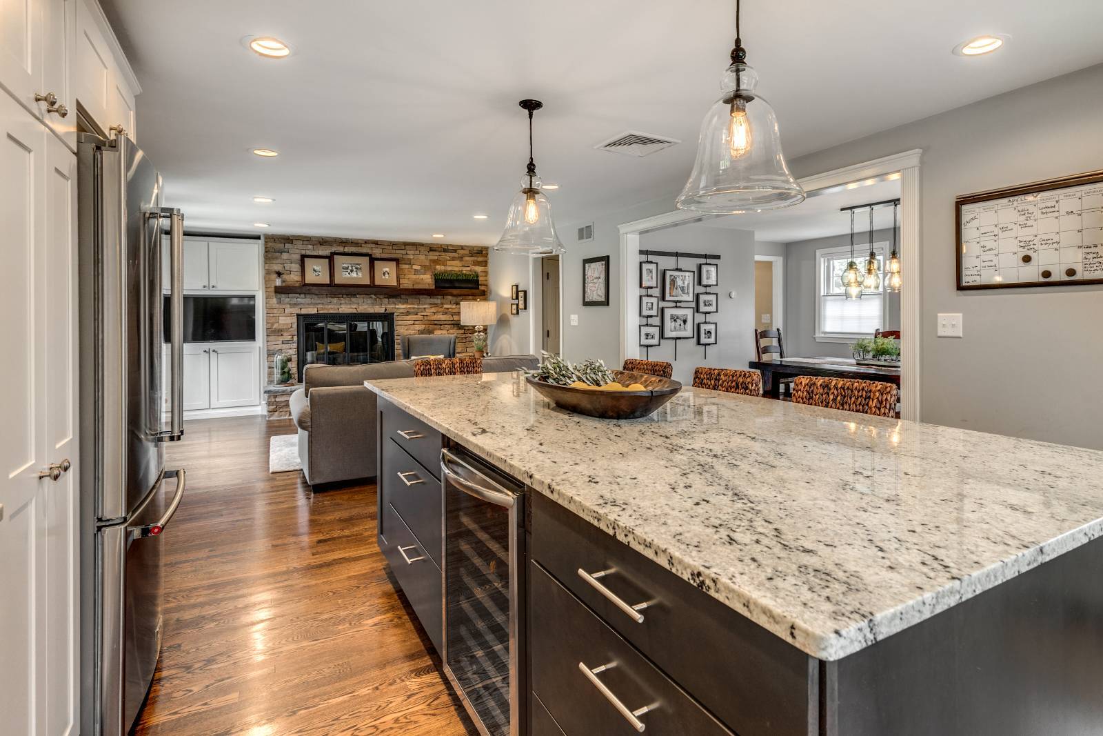 Modern kitchen island and living room view in Lexington, MA remodel by PEGASUS Design-to-Build-optimized