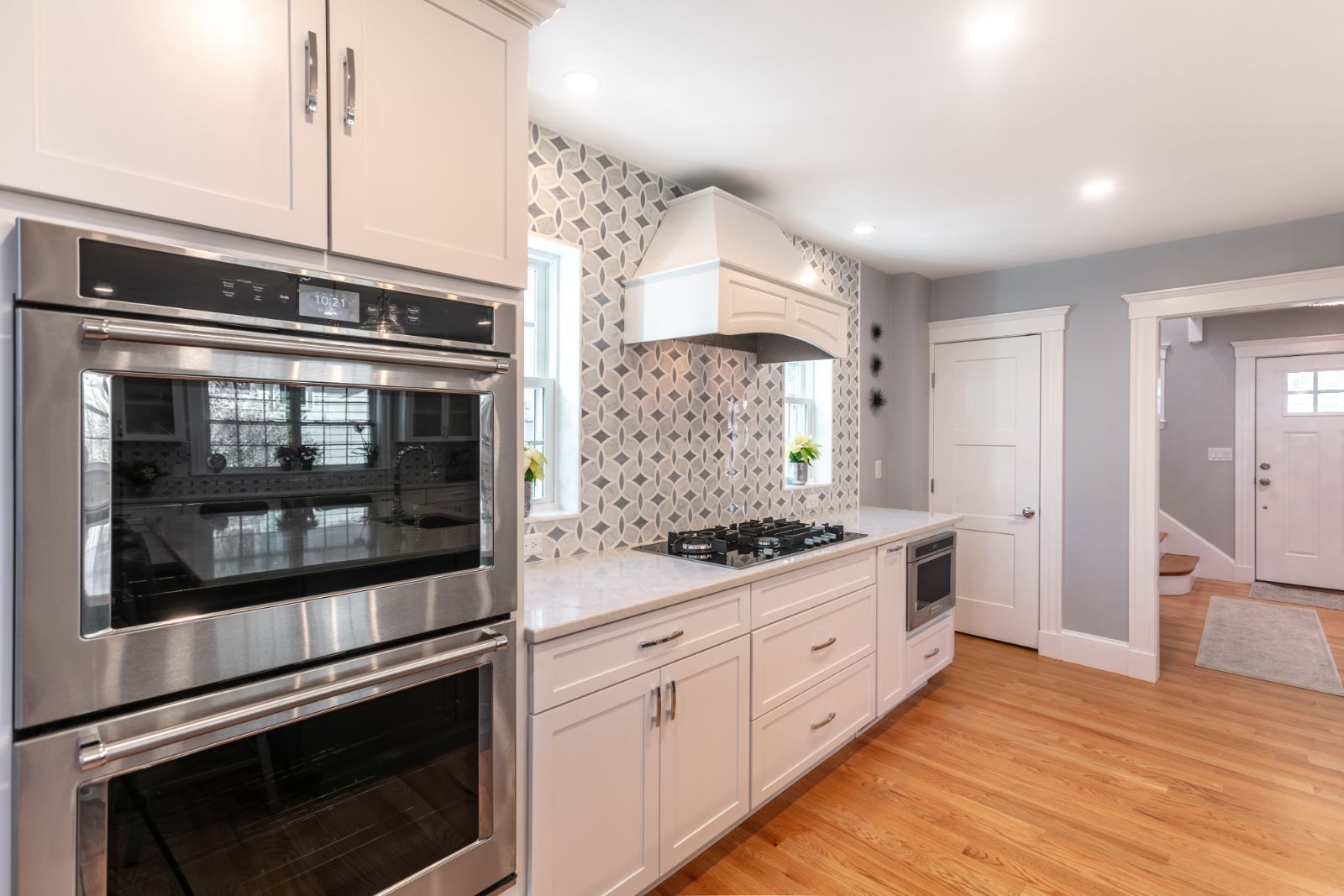white kitchen remodel with gas cooktop and decorative tile backsplash in Melrose MA by PEGASUS Design-to-Build-optimized